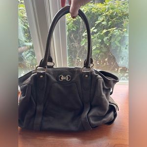 Michael Kors brown pebbled leather purse with bag cover.